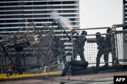 Ecuadorean police shoot tear gas during clashes with demonstrators in the surroundings of the Comptroller General's Office headquarters in Quito, Ecuador, on June 23, 2022.