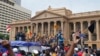 Protesters, many carrying Sri Lankan flags, gather outside the presidents office in Colombo, Sri Lanka, July 9, 2022.