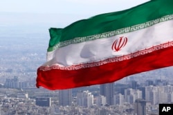FILE - Iran's national flag waves in Tehran, Iran, March 31, 2020.