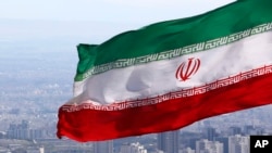 FILE - Iran's national flag waves in Tehran, Iran, March 31, 2020. Iran imposed sanctions Wednesday on individuals and entities from the European Union and Britain in response to recent sanctions placed on the Islamic republic.