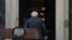 Britain's Prime Minister Boris Johnson walks back into 10 Downing Street in central London after making a statement. Johnson quit as Conservative party leader after three tumultuous years in charge.