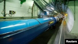 FILE - The Large Hadron Collider (LHC) tunnel is pictured at The European Organization for Nuclear Research (CERN) in Saint-Genis-Pouilly, France, March 2, 2017. (REUTERS/Denis Balibouse)