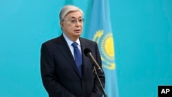 FILE - In this photo released by Kazakhstan's Presidential Press Service, President Kassym-Jomart Tokayev speaks to reporters after voting in the Al-Farabi Schoolchildren Palace in Nur-Sultan, Kazakhstan, June 5, 2022.