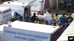 A body is removed from a nightclub in East London, South Africa, June 26, 2022. 