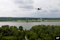 A drone operated by Martin Lively flies with the Potomac River at a distance during a training session in Poolesville, Md. (AP Photo/Julio Cortez)