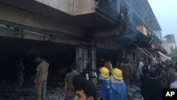 Emergency workers gather at the scene of a car bomb in northern city of Irbil, Iraq, April 17, 2015.