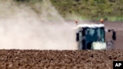 The hot air shimmers in front of a tractor during a long time of drought near Bad Lauchstaedt, Germany, April 27, 2020. 