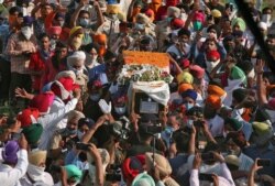 People carry the coffin of Satnam Singh, an Indian soldier who was killed in a border clash with Chinese troops in Ladakh region, during his fuenral ceremony in Bhojraj village in Gurdaspur, Punjab India, June 18, 2020.