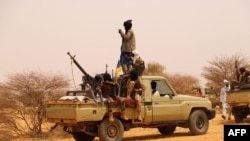 FILE - An anti-aircraft gun is mounted on the back of a pickup truck as Tuareg militants gather in the desert outside Menaka, Mali, March 14, 2020. Tuareg rebels say they killed at least 84 Russian Wagner mercenaries and 47 Malian soldiers in late July 2024.