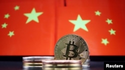 Representations of Bitcoin cryptocurrency are seen in front of an image of Chinese flags in this illustration picture taken June 2, 2021. 
