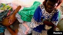 Jonas Lukano, 60, who is has diabetes, is watched over by his sister at the state general hospital in Congo's capital of Kinshasa. (file photo)