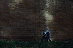 Masked police officers patrol the quiet city centre during a lockdown to curb a coronavirus disease (COVID-19) outbreak in Sydney, Australia, August 20, 2021.