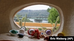 In this photo taken Monday, April 1, 2019, a window in a sunken room called "The Happy Place," looks out on Interstate 280 from inside the Flintstone House in Hillsborough, Calif.