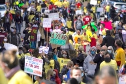 In this March 13, 2021, file photo, parents, students, teachers and supporters march during a rally for San Francisco public schools to reopen during the coronavirus pandemic in San Francisco. (AP Photo/Jeff Chiu, File)