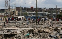 Residents gather during a clash over the demolition of homes at the Mukuru Kwa Njenga informal settlements in Nairobi, Dec. 27, 2021.