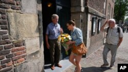 People arrive to pay tribute to attacked journalist Peter R. de Vries at Westerkerk church in Amsterdam, Netherlands, Friday, July 9, 2021. 