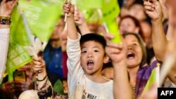Supporters of Taiwan's President Tsai Ing-Wen, from the ruling Democratic Progressive Party (DPP), wave campaign flags during a rally in Taipei, Jan. 10, 2020. 