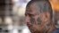 FILE - a gang member of MS-13 attends mass at a prison in Ciudad Barrios, El Salvador. MS-13, or the Mara Salvatrucha, is believed by federal prosecutors to have thousands of members across the U.S., primarily immigrants from Central America. 