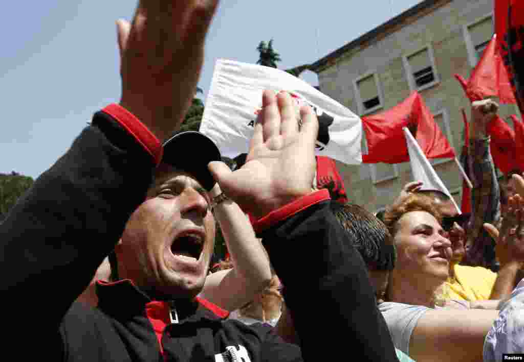 Supporters of the Albanian Red and Black Alliance party shout slogans during a May Day protest in front of the Albanian prime minister&#39;s office in Tirana, May 1, 2013. 