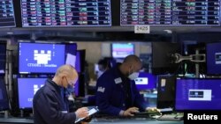 FILE - Traders work on the trading floor at the New York Stock Exchange in New York City, Dec. 28, 2021. 