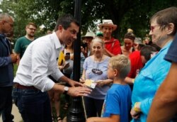 FILE - Democratic presidential candidate Pete Buttigieg meets with people at a campaign event Aug. 15, 2019, in Fairfield, Iowa.