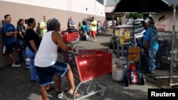 Paul Akamine fills propane tanks for customers as Hurricane Lane approaches Honolulu, Hawaii, Aug. 22, 2018. 