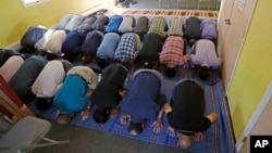 FILE - Muslim worshipers pray during a service at the Bernards Township Community Center in Basking Ridge, New Jersey, Sept. 23, 2016. Bernards Township has settled a lawsuit with the local Muslim community over the township's denial of a permit to build a mosque.