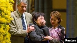 On Australia's national day of mourning for victims of downed Malaysia Airlines flight MH-17, a relative grieves during a service at St. Patrick’s Cathedral in Melbourne Aug. 7, 2014. 