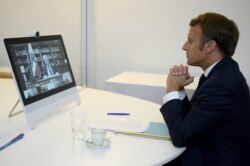 FILE - French President Emmanuel Macron attends a donor teleconference with other world leaders concerning the situation in Lebanon following the Beirut blast, in Fort de Bregancon in Bormes-les-Mimosas, France Aug. 9, 2020.