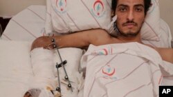 Syrian Ejnad Akkad, a fighter for the Syrian opposition Free Syrian Army, who was wounded by a mine planted by the Islamic State group near the border with Turkey, lays on his bed at a hospital in Kilis, Turkey, Feb. 9, 2016.