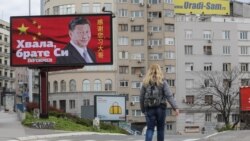 រូបឯកសារ៖ ស្ត្រី​ម្នាក់​ដើរ​កាត់​ផ្ទាំង​ប៉ាណូ​មួយ​ដែល​សរសេរ​ថា «សូម​ថ្លែង​អំណរគុណ បង​ Xi» ​ក្នុង​ទីក្រុង​ប៊ែលក្រាដ ប្រទេស​ស៊ែកប៊ី កាល​ពី​ថ្ងៃទី១ ខែមេសា ឆ្នាំ២០២១។