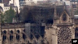 Notre Dame cathedral is pictured from the top of the Montparnasse tower, April 16, 2019, in Paris, France. Firefighters declared success Tuesday morning in an over 12-hour battle to extinguish an inferno engulfing Paris' iconic cathedral.