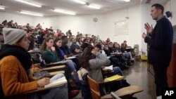 Students at New York's Brooklyn College attending a chemistry lecture. It is one of the schools that would benefit from law providing free tuition for students at public colleges who are part of families that earn $125,000 or less per year. (AP Photo by Bebeto Matthews)