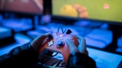 A boy plays a game on Xbox at the Paris Games Week in Paris, Friday, Nov. 3, 2017. (AP Photo/Kamil Zihnioglu)