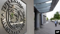 International Monetary Fund logo is seen outside the headquarters building during the IMF/World Bank spring meeting in Washington, U.S., April 20, 2018. REUTERS/Yuri Gripas - RC13CB8CD000