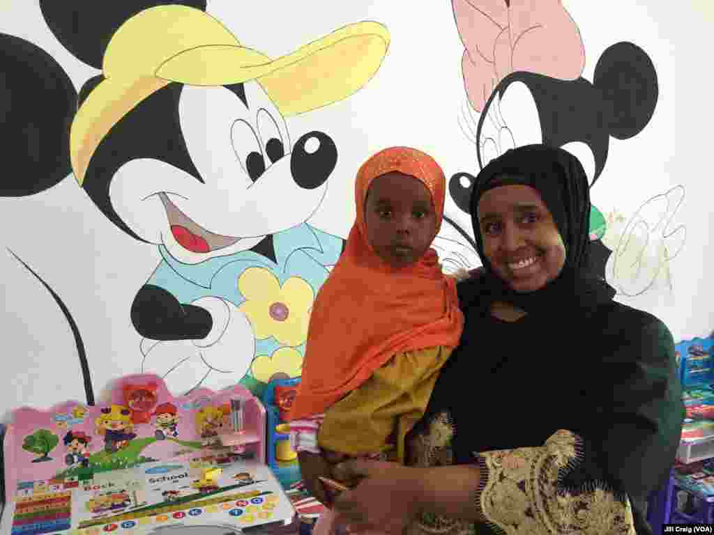 Huda Haroon Awjama, manager of the Peaceful Coexistence Center, holds a child of a refugee, in Hargeisa, Somaliland, April 3, 2016. The Center provides language and literacy classes for both refugees and Somalilanders, and is a place for people to gather.