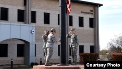 Members of a flag detail lower the flag in front of the Norma Brown Building on Goodfellow Air Force Base, Texas, March 16, 2018. (Airman 1st Class S. Hines / USAF)