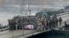 FILE - U.S. and South Korean army soldiers pose on a floating bridge on the Hantan river after a river crossing operation, part of an annual joint military exercise between South Korea and the United States in Yeoncheon, South Korea, Dec. 10, 2015.