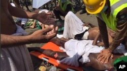 A pilgrim is treated by a medic after a stampede that killed and injured pilgrims in the holy city of Mina during the annual hajj pilgrimage, Sept.24. The image was posted on the official Twitter account of the directorate of the Saudi Civil Defense agency.