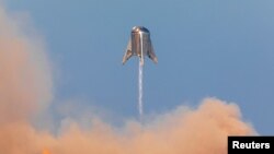 SpaceX's Mars Starship prototype "Starhopper" hovers over its launchpad during a test flight in Boca Chica, Texas, Aug. 27, 2019.