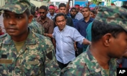 Maldivian President Abdulla Yameen, center, surrounded by body guards arrives to address supporters in Male, Feb. 3, 2018.