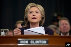 FILE - Democratic presidential candidate, former Secretary of State Hillary Rodham Clinton looks toward the dais as she settles into her seat prior to testifying before the House Benghazi Committee, on Capitol Hill in Washington, Oct. 22, 2015.
