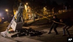 Activists in Poland pull down a statue of a prominent deceased priest, Father Henryk Jankowski, who allegedly abused minors sexually, in Gdansk, Poland, Feb. 21, 2019.