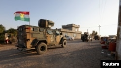 FILE - Iraqi forces and Kurdish Peshmerga fighters take part in an intensive security deployment in Luhaiban village in Kirkuk, Iraq, Dec. 6,2021.