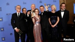 The cast and crew of "The Crown" pose together after winning the Golden Globe award for Best Television Series - Drama as star Claire Foy holds her award for Best Performance by an Actress In A Television Series - Drama, Jan. 8, 2017.