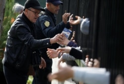Volunteers distribute food at a makeshift camp in Durres, after an earthquake shook Albania, Nov. 29, 2019.