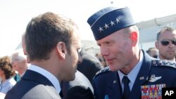 FILE - In this June 19, 2017 file photo, French President Emmanuel Macron, meets with Gen. Tod Wolters, while visiting the Paris Air Show in Le Bourget, north of Paris.