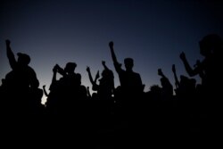 FILE - Protesters hold their fists in the air during a rally June 5, 2020, in Las Vegas, sparked by the death of George Floyd, a black man who died after being restrained by Minneapolis police officers on May 25.