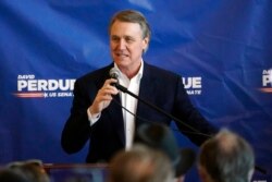 FILE - Republican candidate for Senate Sen. David Perdue speaks during a campaign stop at Peachtree Dekalb Airport in Atlanta, Nov. 2, 2020.
