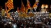 FILE - People light up their mobile phones during a protest called by Catalan pro-independence movements ANC and Omnium Cultural to mark one year of the imprisonment of their leaders Jordi Sanchez and Jordi Cuixart, at Catalunya Square in Barcelona, Spain,